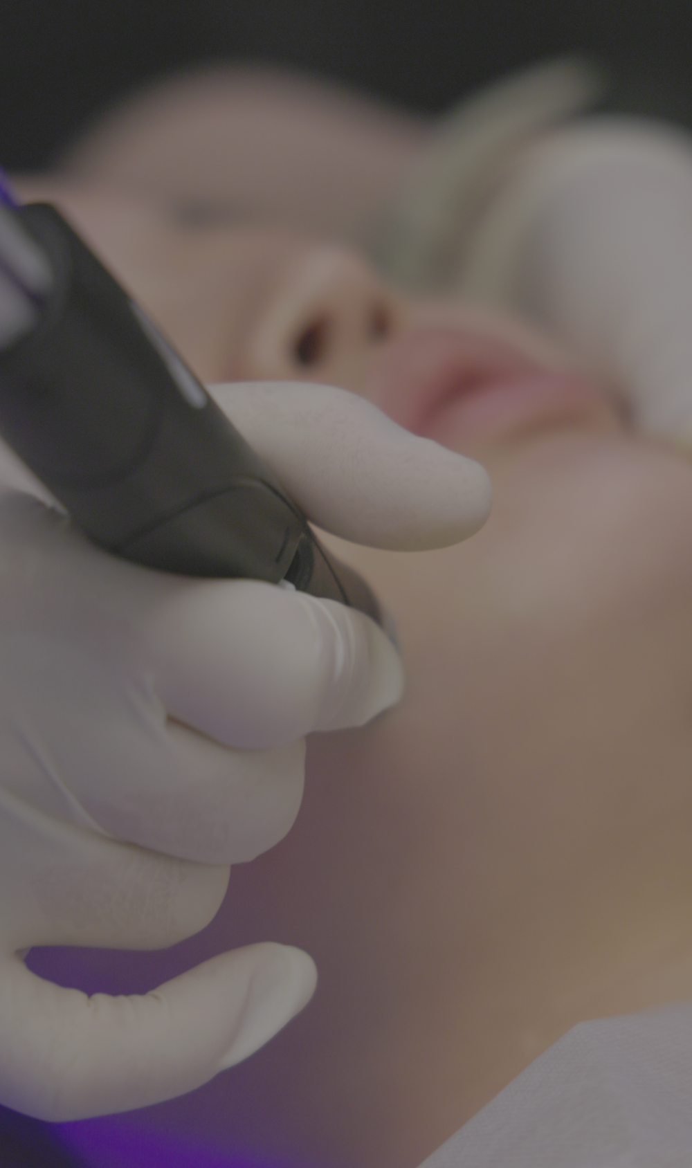 Gloved hands during an aesthetic procedure