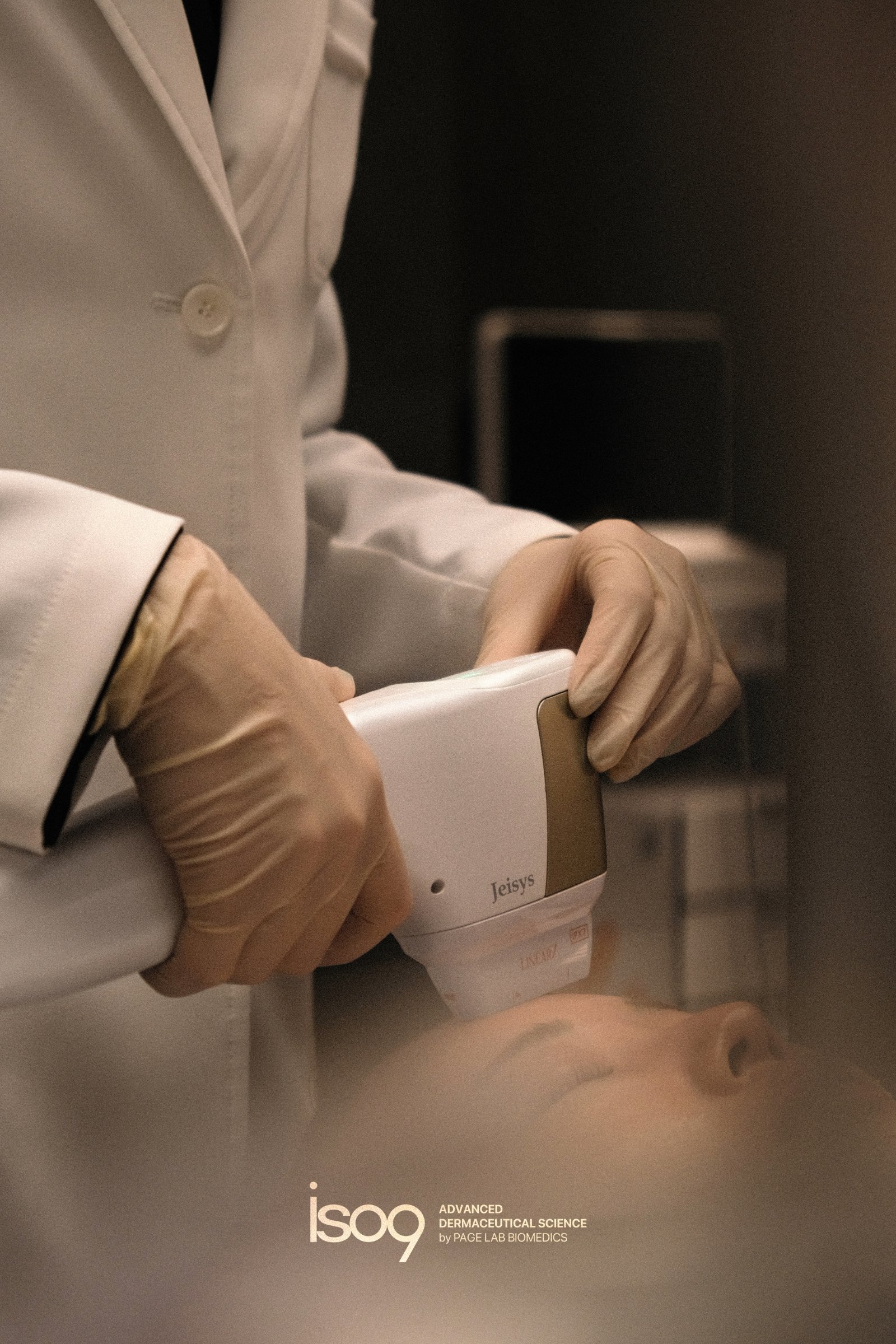 Clinician holding an energy-based device over post-procedure skin